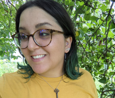 A photo of Leticia standing under a tree